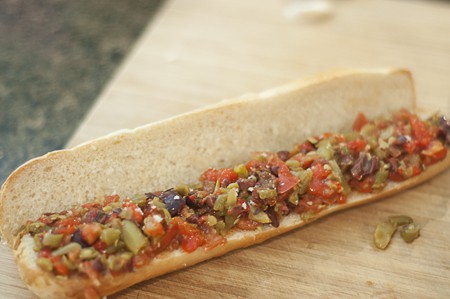 Cut baguette spread with vegetable filling.