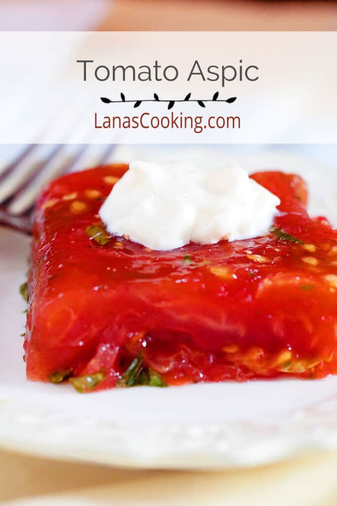 A serving of tomato aspic with a dollop of mayonnaise on top.