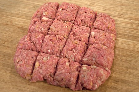 Forming meatballs on a board.
