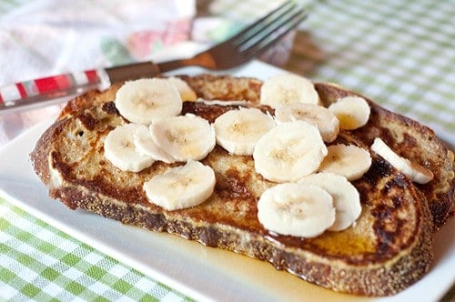 Banana Maple French Toast - whole grain French toast topped with sliced bananas and maple syrup. https://www.lanascooking.com/banana-maple-french-toast