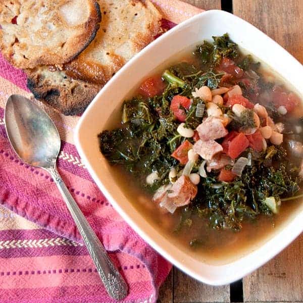 Sausage and kale soup - a hearty fall and winter soup featuring smoky sausage and kale. Serve with your favorite cornbread alongside. https://www.lanascooking.com/sausage-and-kale-soup/