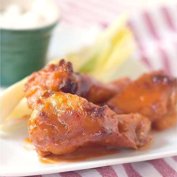 Finished buffalo wings on a serving plate.