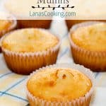 Golden brown lemon and cherry muffins on a decorative napkin.