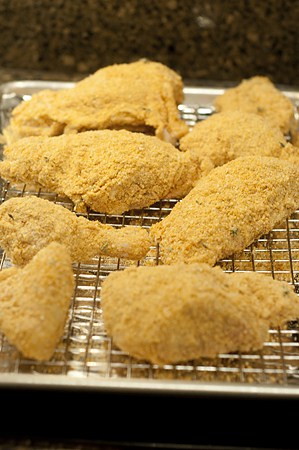 Chicken coated with corn flake crumbs.