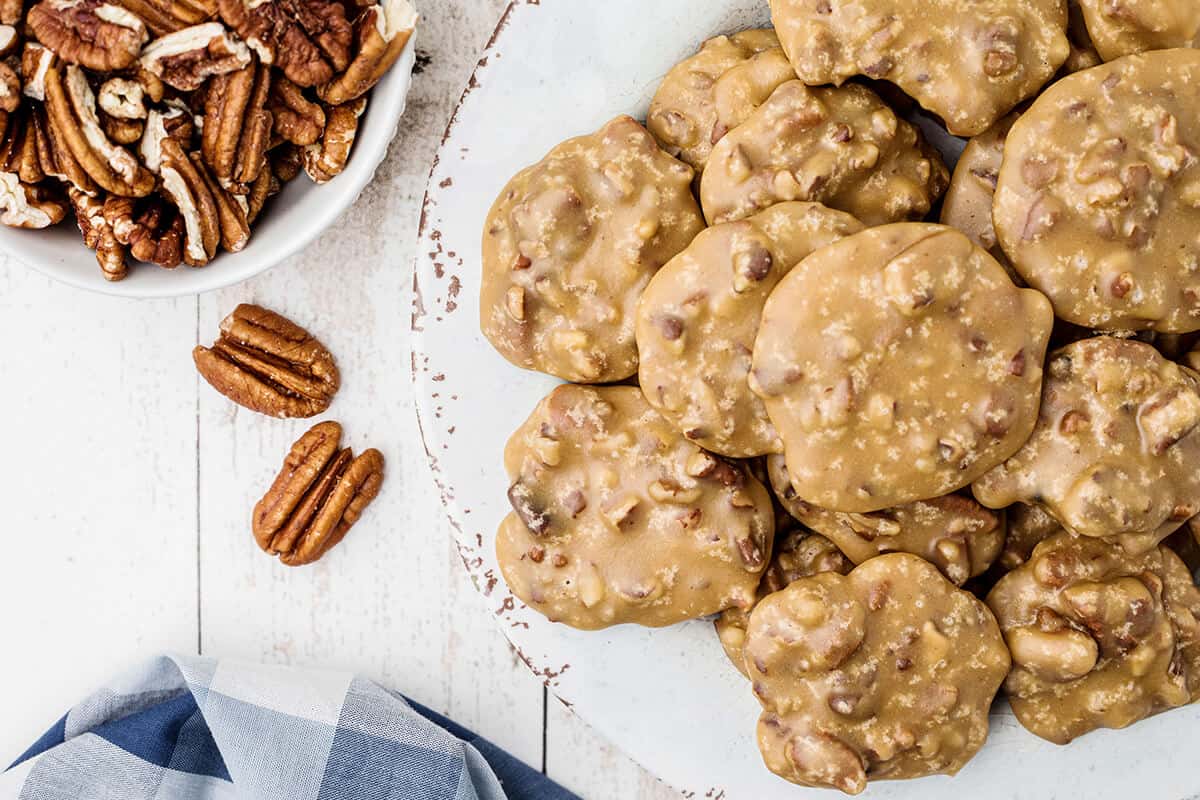 Pecan pralines on a white serving plate.