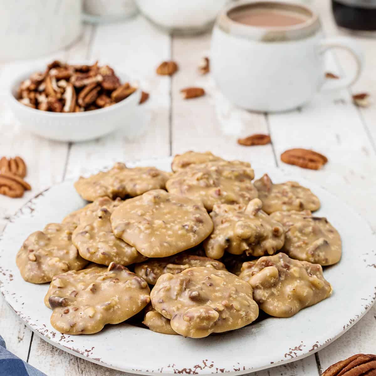 Pecan pralines on a white serving plate.