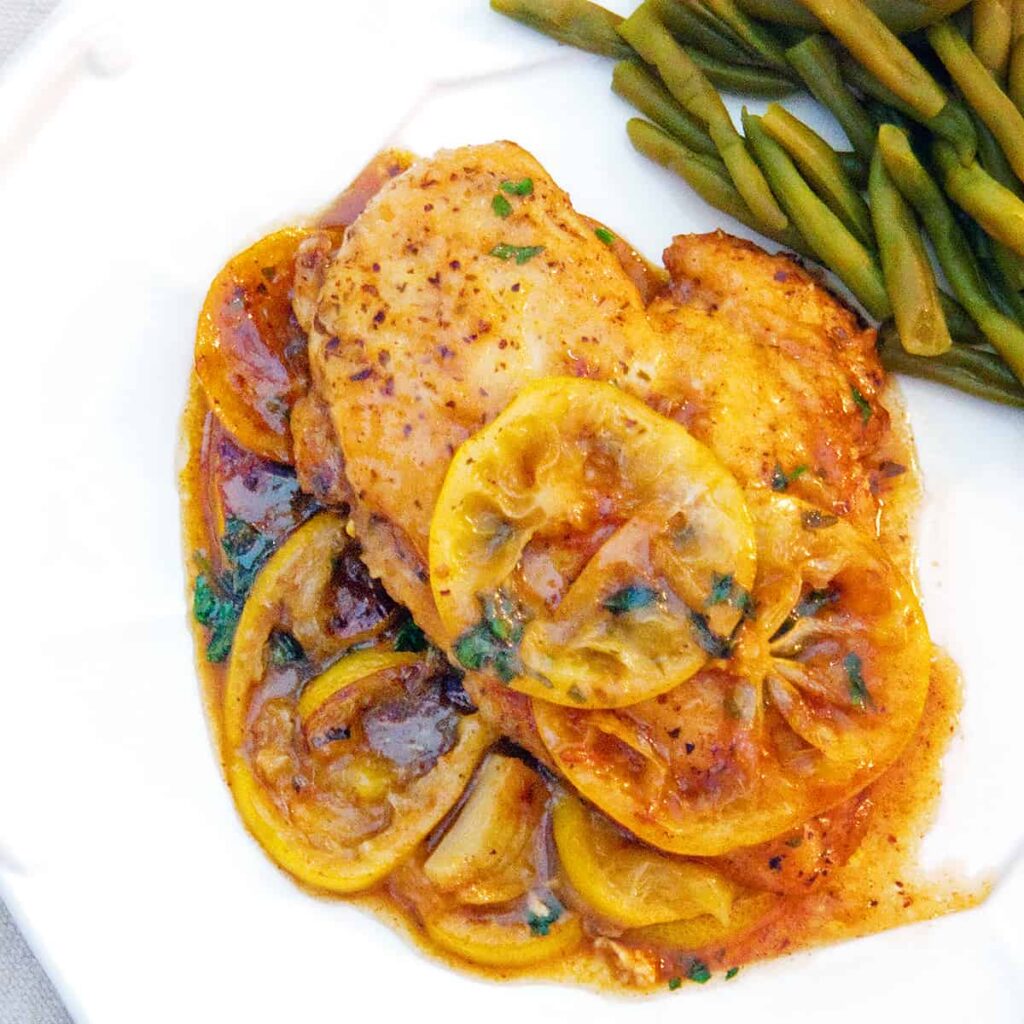 A serving of Meyer Lemon Chicken on a white dinner plate.