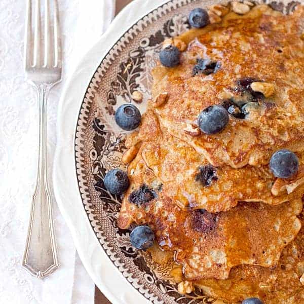 These hearty Oatmeal Blueberry Pancakes are packed full of whole grain oatmeal, blueberry, orange zest, and pecans. https://www.lanascooking.com/oatmeal-blueberry-pancakes/
