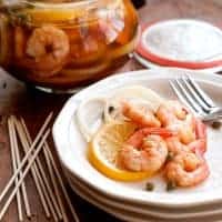 Pickled shrimp - Boiled shrimp layered with lemon slices, onion, and capers and marinated in cider vinegar. Serve with cocktail sauce on the side. https://www.lanascooking.com/pickled-shrimp/