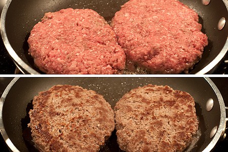 Beef patties cooking in a skillet.