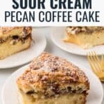 Slices of sour cream coffee cake on a white plate with a gold fork.