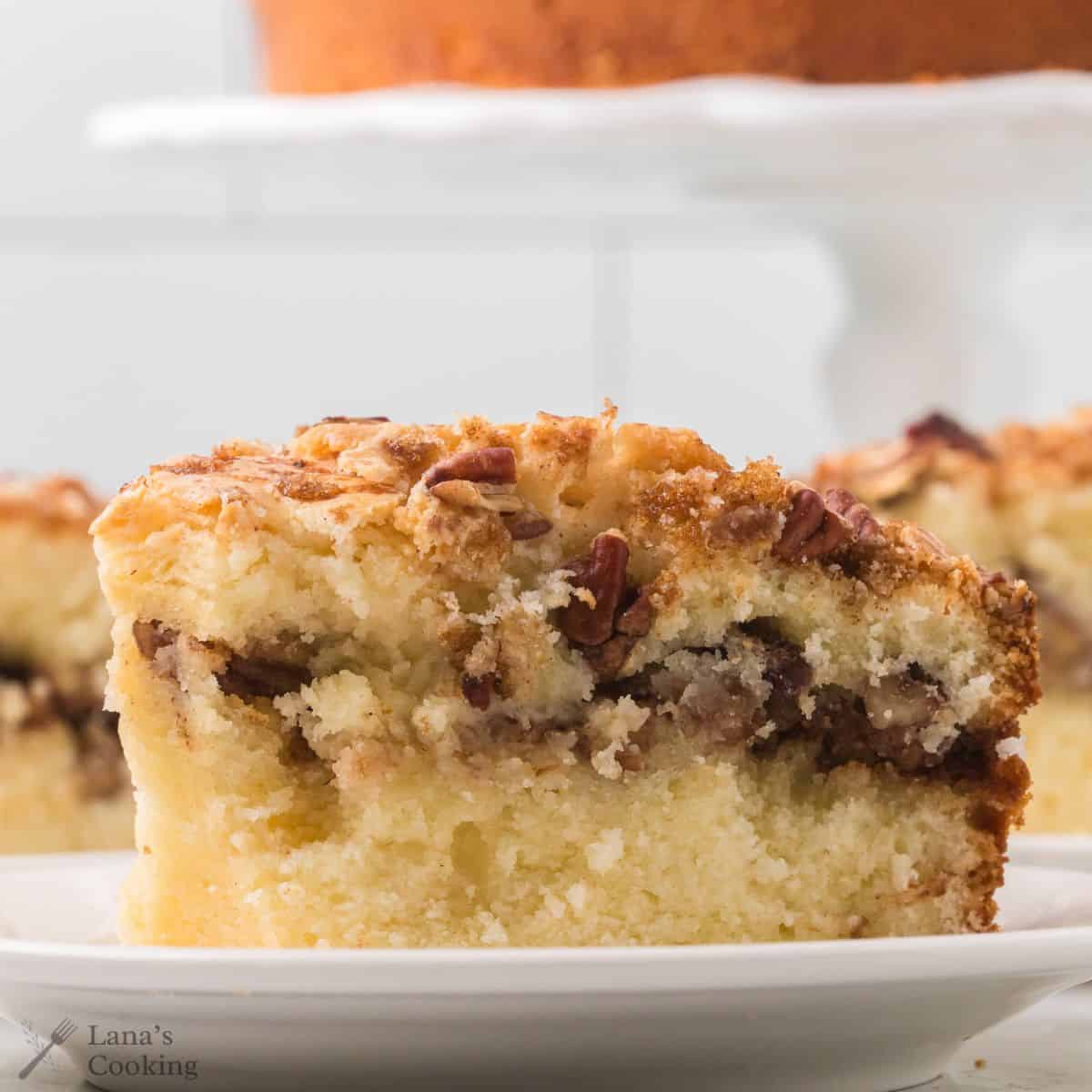 A slice of coffee cake on a white plate.