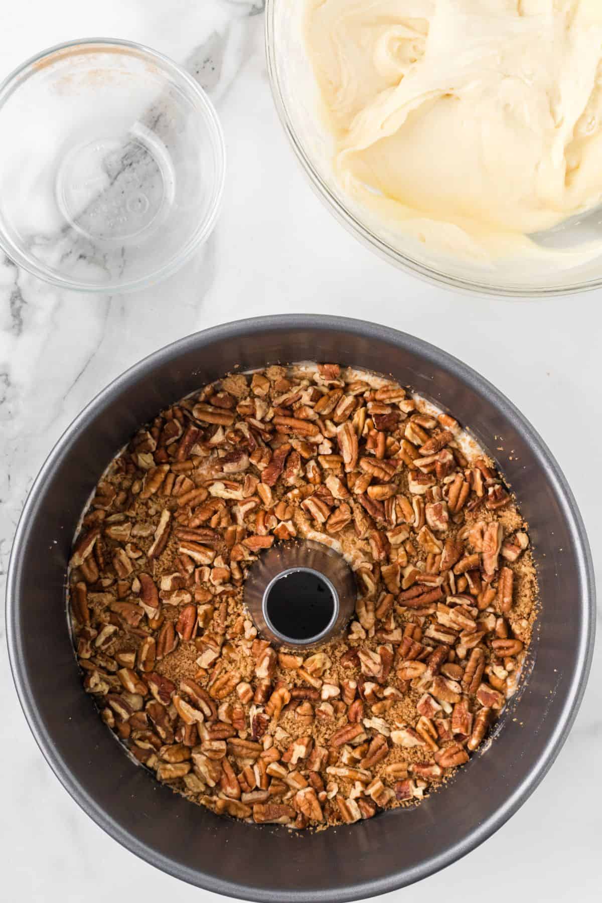Half of the pecan mixture sprinkled over the batter in the pan.