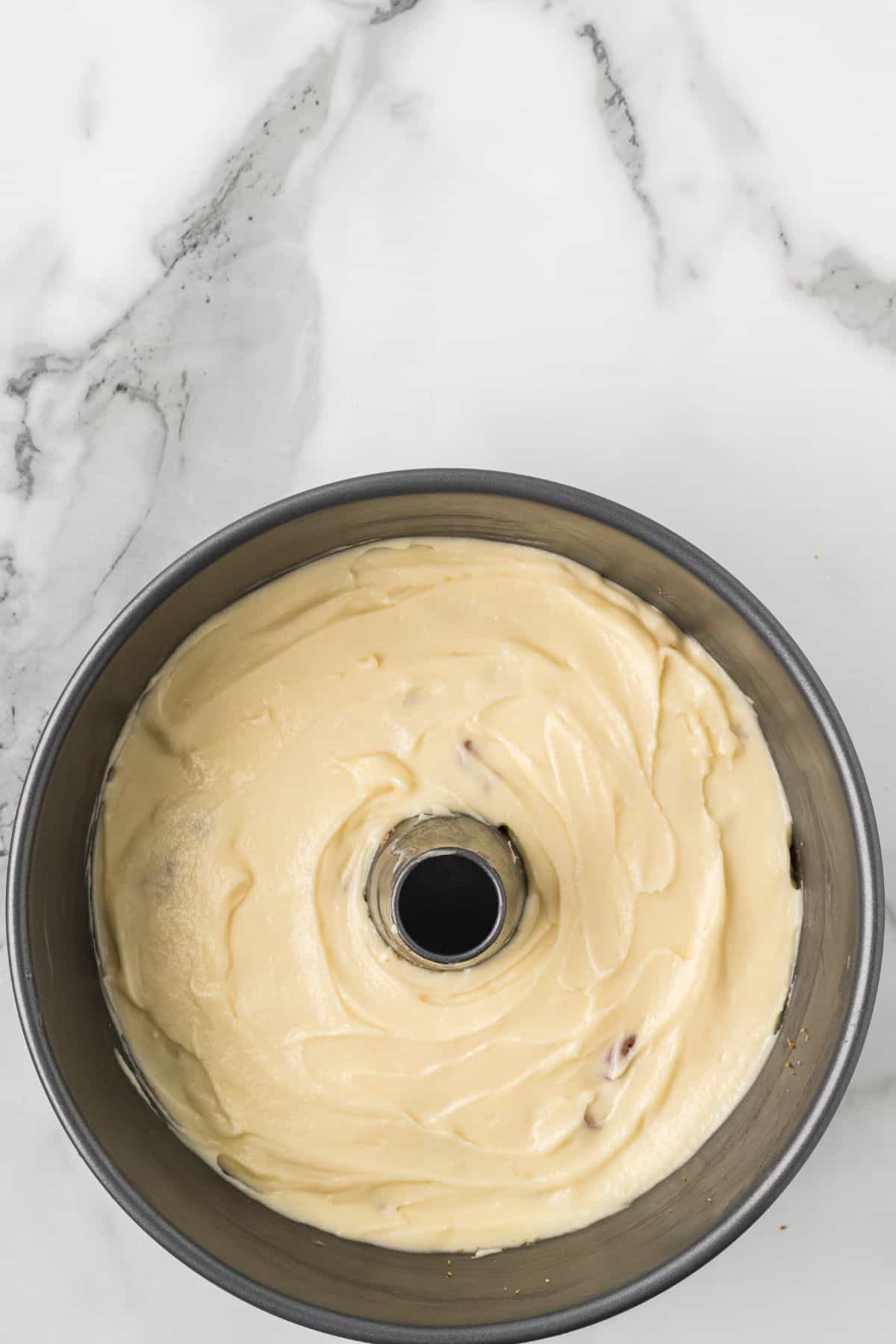 The remaining half of the coffee cake batter spread over the pecan filling.