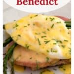 Eggs Benedict with ham, asparagus, and hollandaise sauce on toast, garnished with chopped chives.