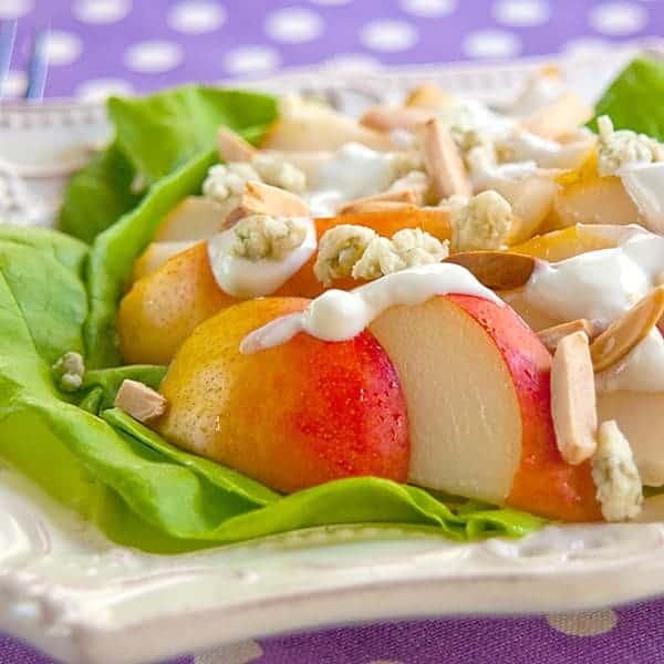 This Fresh Pear Salad with Blue Cheese Dressing is composed of sliced pears topped with tangy blue cheese dressing and toasted slivered almonds. https://www.lanascooking.com/pear-salad-with-blue-cheese-dressing/