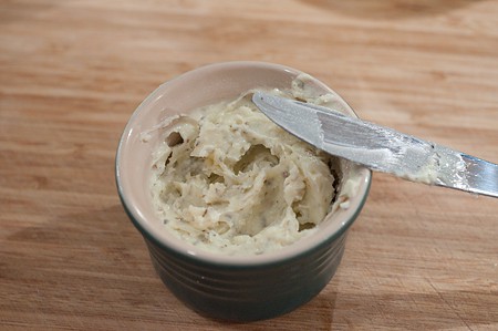 Butter, cheese, and oregano mixed in a small bowl.