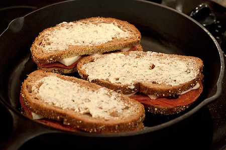 Sandwiches cooking in a skillet.