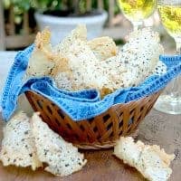Asiago Cheese Crisps - Crispy chips of baked asiago cheese, minced sage, and chopped pine nuts. https://www.lanascooking.com/asiago-cheese-crisps/