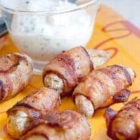 Bacon Wrapped Fingerling Potatoes - roasted fingerling potatoes wrapped in bacon and served with a creamy dipping sauce. https://www.lanascooking.com/bacon-wrapped-roasted-fingerling-potatoes/