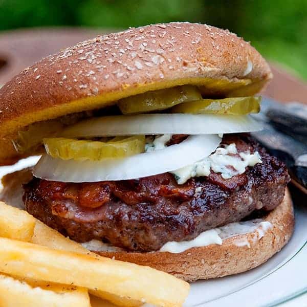 BeeBop's Bacon Cheeseburger is a unique burger that has the bacon cooked right on top of the burger. It's totally delicious and really easy to make! https://www.lanascooking.com/beebops-bacon-cheeseburger/