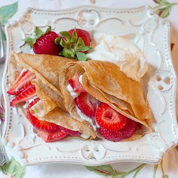 Strawberry Filled Whole Wheat Crepes - whole wheat crepes filled with fresh strawberries and lightly sweetened whipped cream. https://www.lanascooking.com/strawberry-filled-whole-wheat-crepes/