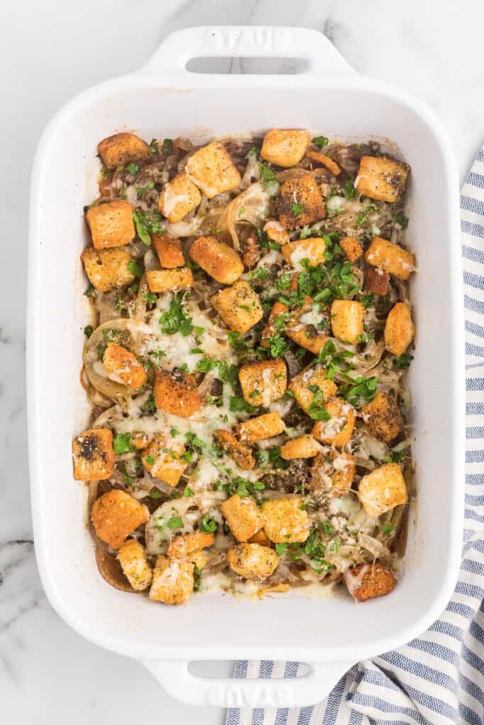 Finished gratin with melted cheese in a baking dish.