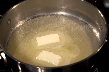 Melting butter for Mediterranean Shrimp Melting butter in a skillet.