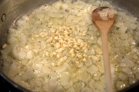 Cooking onion and garlic with butter in a skillet.