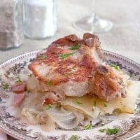 Pork Chops with Potatoes - a very old French recipe for slow cooked pork chops, onions, and potatoes. Melt in your mouth delicious! https://www.lanascooking.com/pork-chops-with-potatoes/