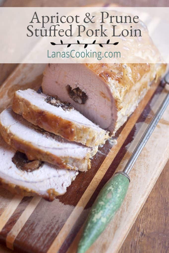 Sliced Apricot and Prune Stuffed Pork Loin on a serving tray. Text overlay for pinning.