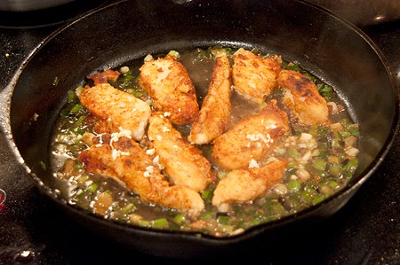 Chicken strips added back to skillet with the cooked green onions and broth.