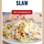 A plate of hot cabbage slaw with carrots and seasonings, served on a white dish.