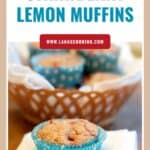 A strawberry lemon muffin in a blue wrapper on a napkin, with more muffins in a basket in the background.