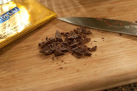 Chopping chocolate on a board.