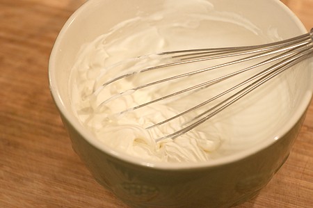 Whipping cream with a whisk.
