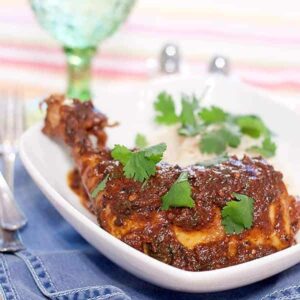 This Indian inspired Coriander Chicken with Cilantro Rice uses inexpensive chicken leg quarters along with flavorful spices to make a quick and easy meal. https://www.lanascooking.com/coriander-chicken-with-cilantro-rice/