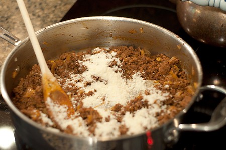 Adding Parmesan cheese to filling.