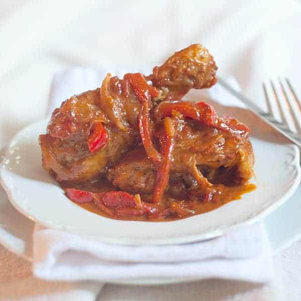 Paprika chicken - smothered or etouffeed chicken with peppers, onions, and fennel. Cooked low and slow for a rich, luscious dish. https://www.lanascooking.com/paprika-chicken