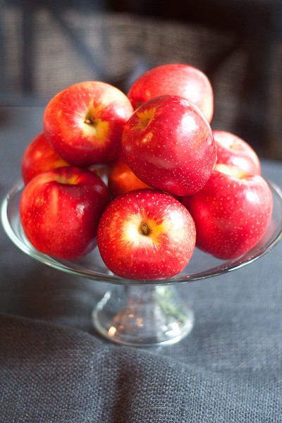 SweeTango apples on a glass cake plate.