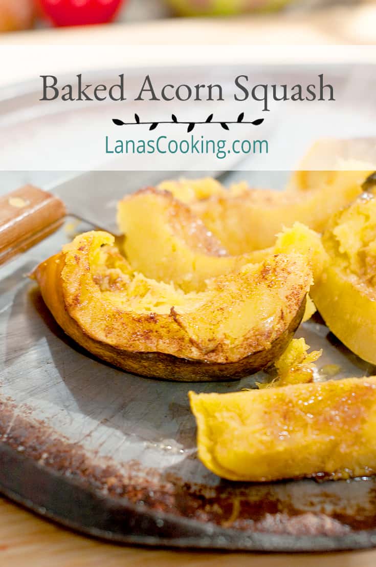 Baked Acorn Squash on a baking sheet with a chef's knife in the background. Text overlay for pinning.