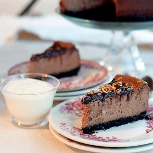 A serving of chocolate coconut cheesecake on a decorative plate.