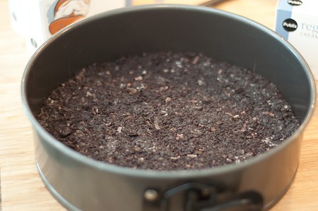 Crust mixture patted into the bottom of a springform pan.