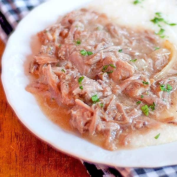 Slow Braised Pork Rib Ragu - pork spareribs are slowly braised with aromatic vegetables and served over hot buttered grits. https://www.lanascooking.com/pork-rib-ragu/