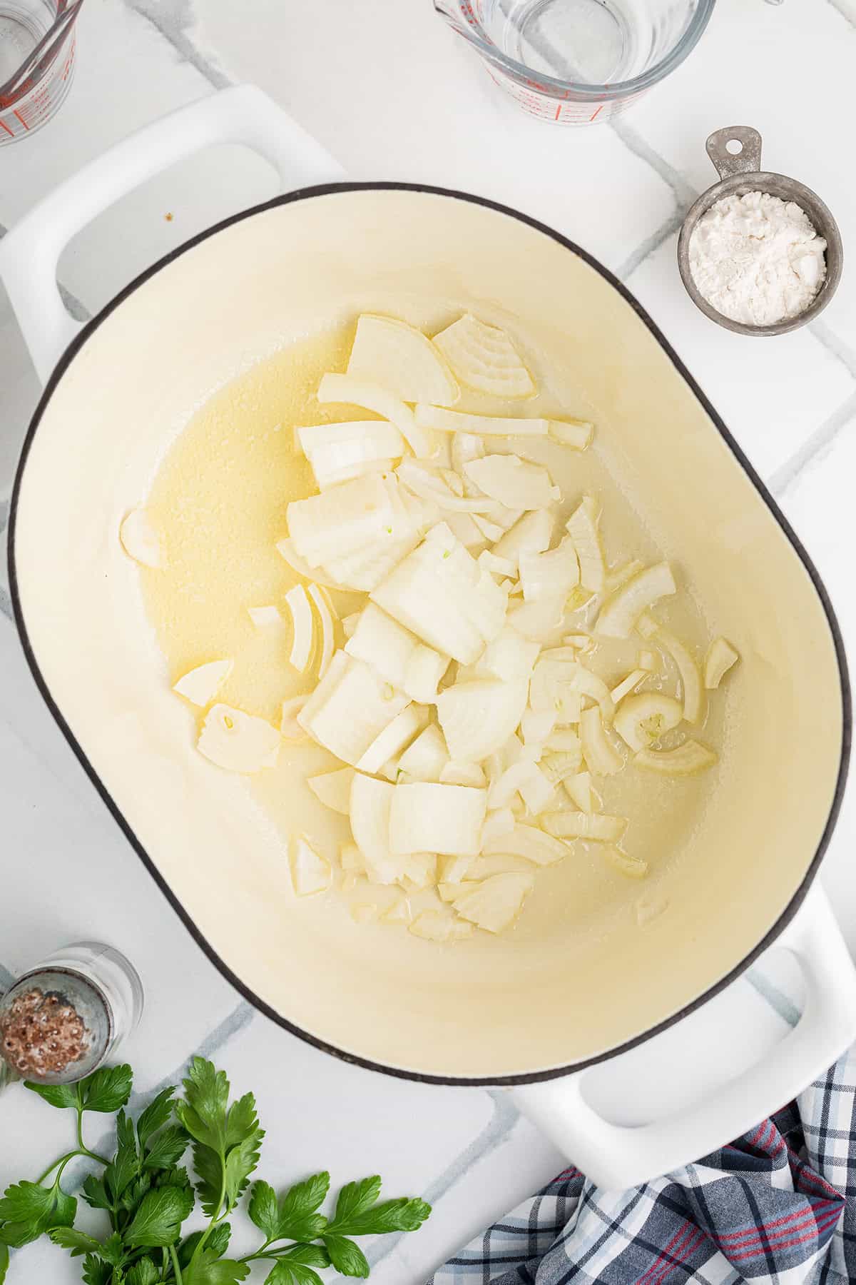 Melted butter and onions in a pan.