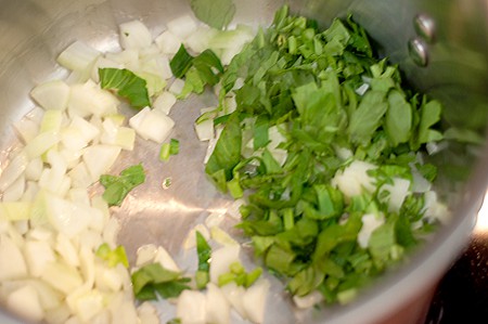Cooking onions and celery in a soup pot.