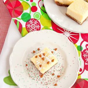 Peanut Butter Chocolate Chunk Cookie Cheesecake Squares - these delicious cheesecake squares are easy to make using a packaged cookie mix for the crust. https://www.lanascooking.com/peanut-butter-chocolate-chunk-cookie-cheesecake-squares/