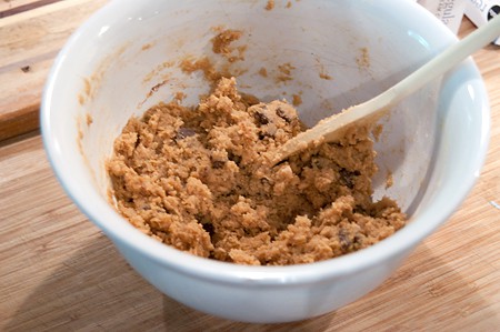 Mixing cookie dough crust in a bowl.