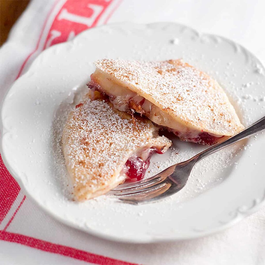 Two quesadillas on a serving plate.