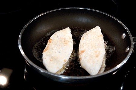 Quesadillas cooking in a skillet.